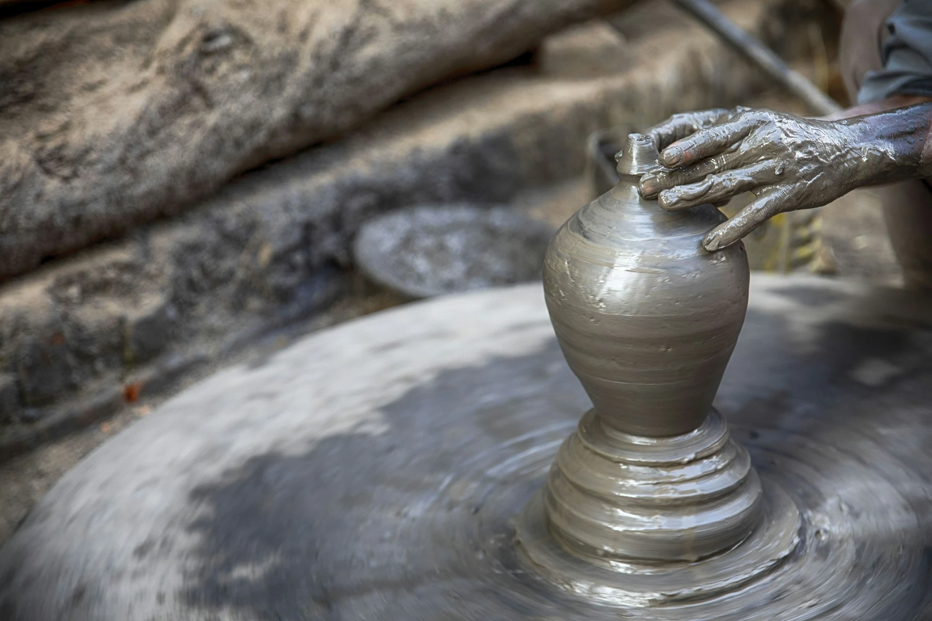 A potter shaping a clay vessel on a wheel in Bhaktapur, Nepal